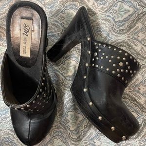 Used black slip on shoes with silver studs.